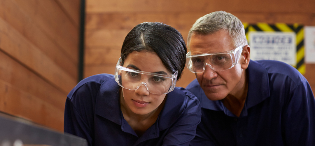 man teaching younger woman at work