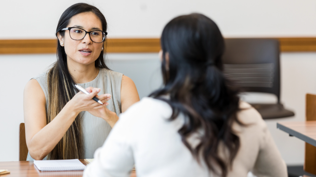 Two people discussing probationary review