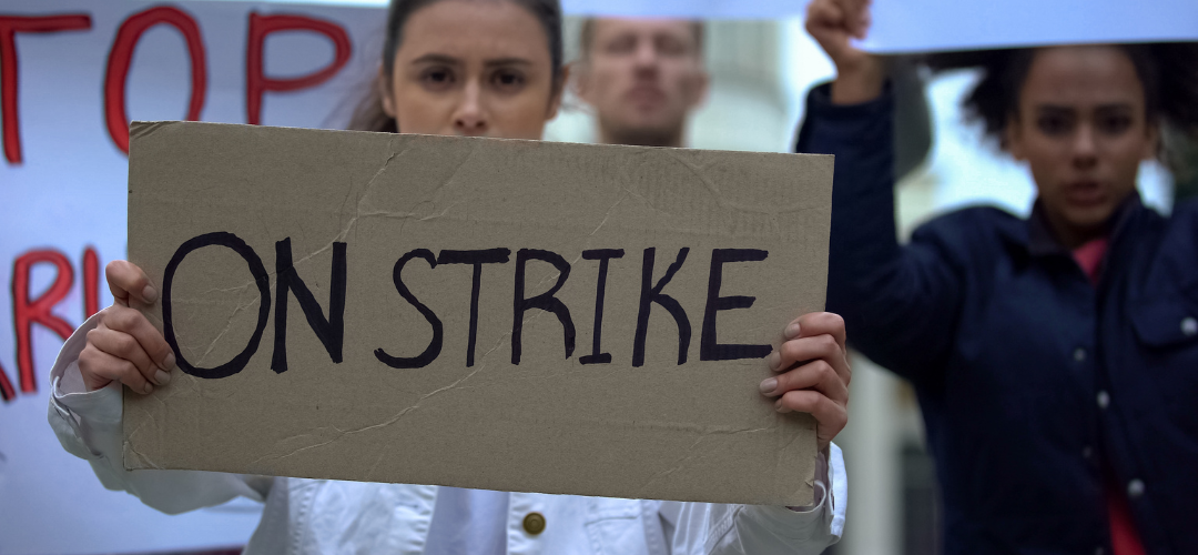 woman holding up strike sign